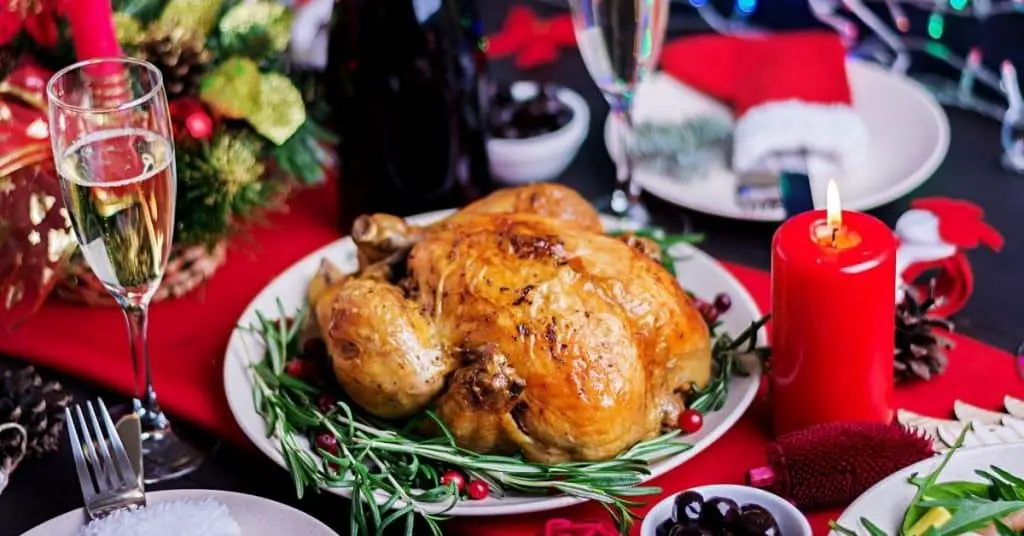 Turkey on Table with wine and candle decorated in seasonal festive decor