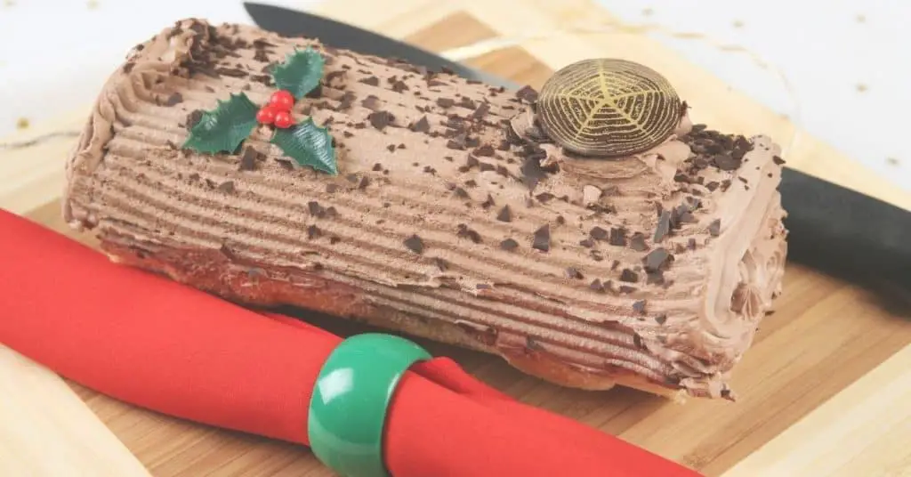Yule Log Cake Decorated with Chocolate and Holly - Open for Christmas