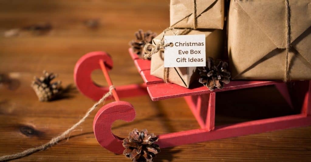 The Best Christmas Eve Box Gift Ideas for Adults Wrapped Up on a Festive Sleigh with Decorations - Open for Christmas